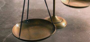 Scales of justice on table, closeup. Law concept