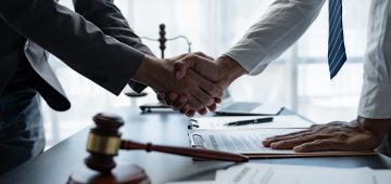The handshake after a good cooperation, consulting between attorney and client, businessman, tax and real estate project company. Law and justice concept